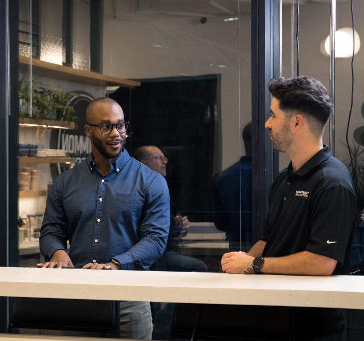 Two men talking while standing